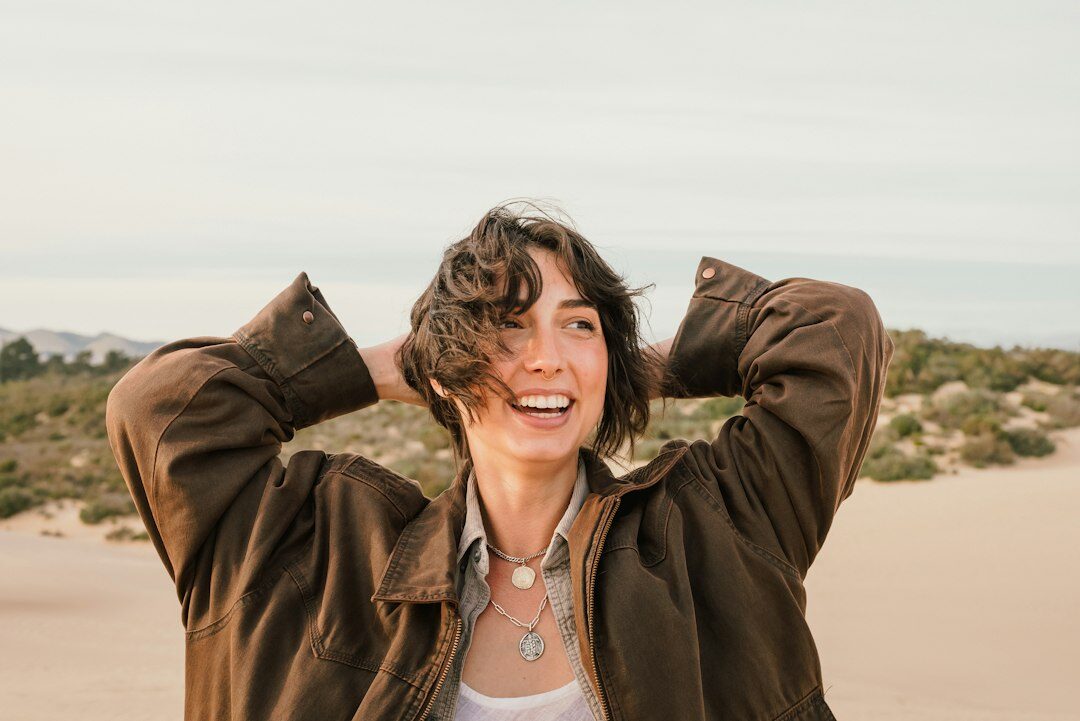 Studio portrait of a middle-aged Swiss woman with short brown hair smiling warmly